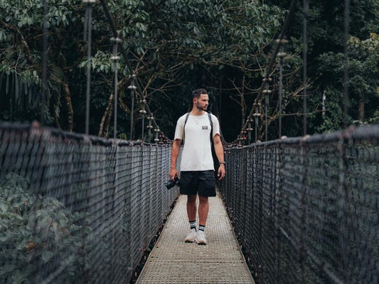 NIKIN ambassador outside with the camera on a bridge.